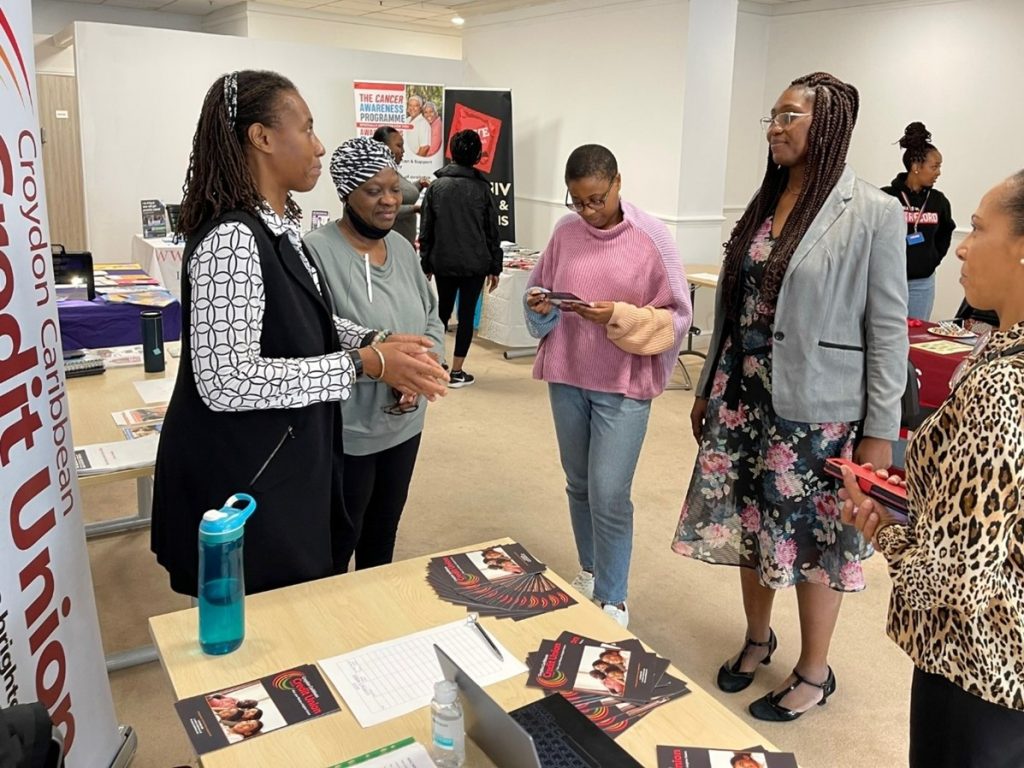 Dr Glora Rowland talking to members of the Croydon Caribbean Credit Union team