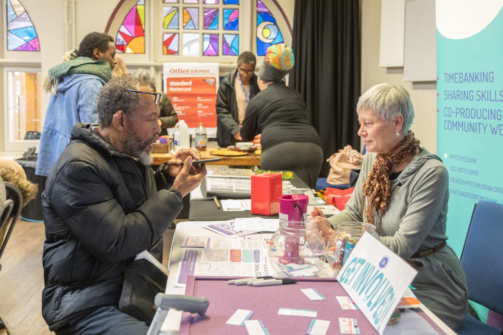 Local resident talking to organisation at stall.
