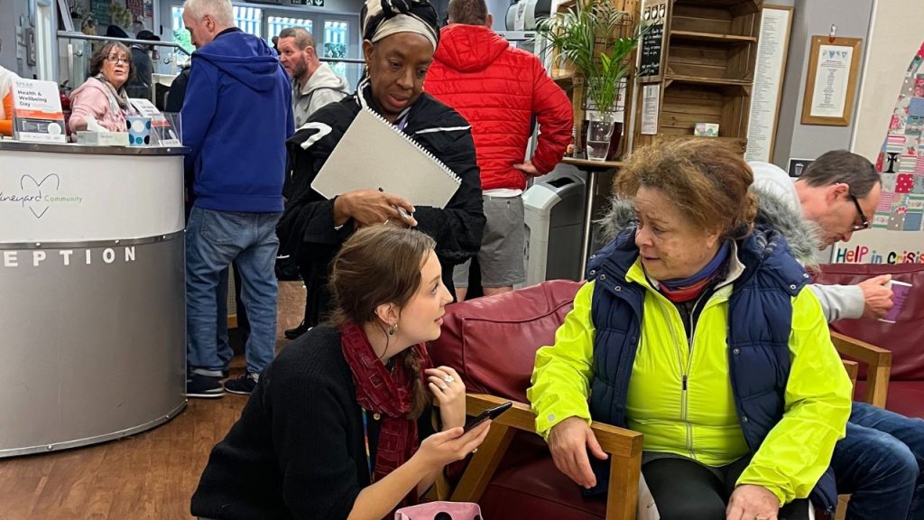 Grace Kettlewell, SPEAR's health link worker talks to clients at the charity's reception.