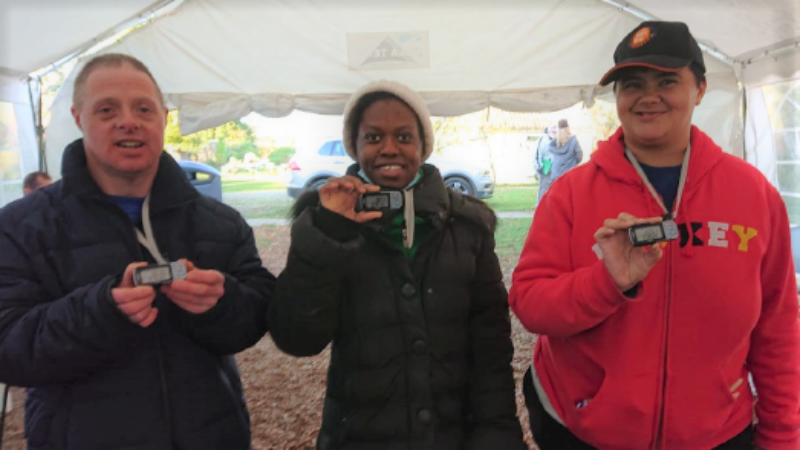 Three students at Share show off their pedometers