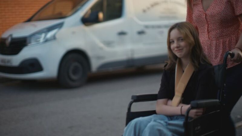 12 year old Lily Bannister being pushed in a wheelchair