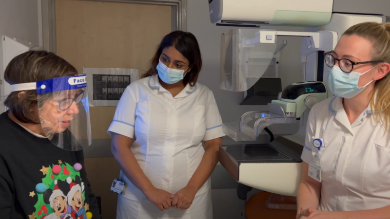 Sutton Mencap member talking to two healthcare professionals