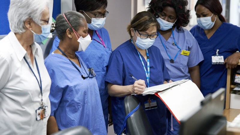 A group of nurses at Croydon University Hospital looking at notes preparing for ward rounds